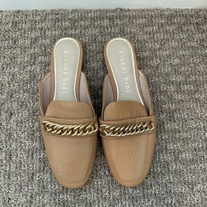 Tan mules with gold chain accent.